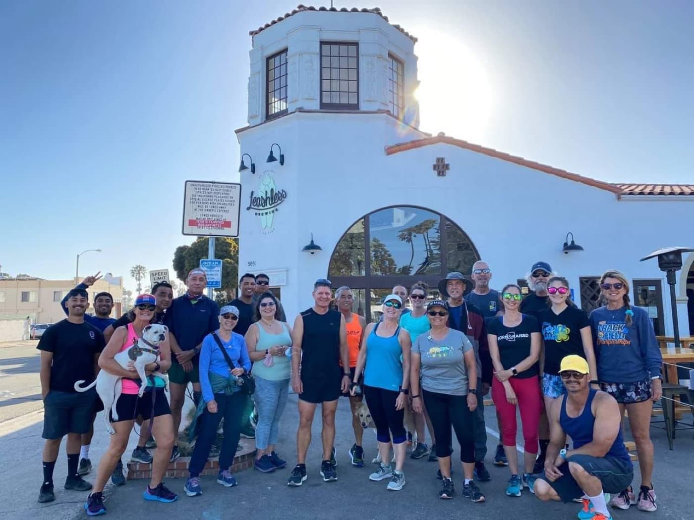 Club members posing in front of a building